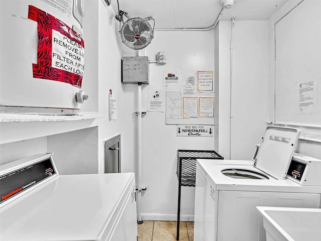 laundry area with light tile patterned flooring and independent washer and dryer