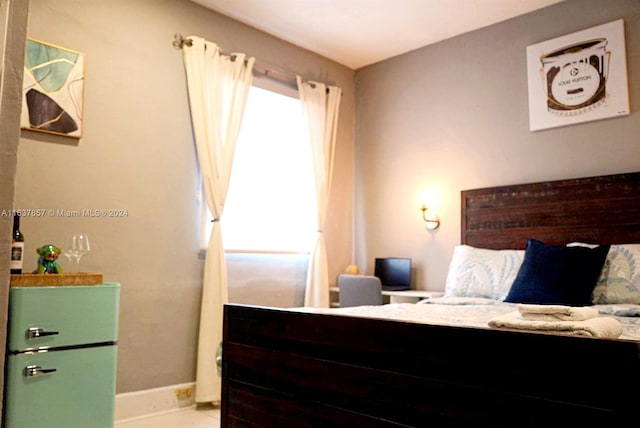 bedroom featuring tile patterned floors and baseboards