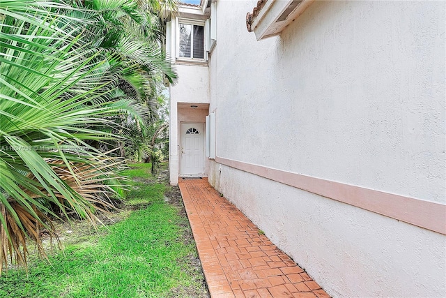 entrance to property featuring stucco siding