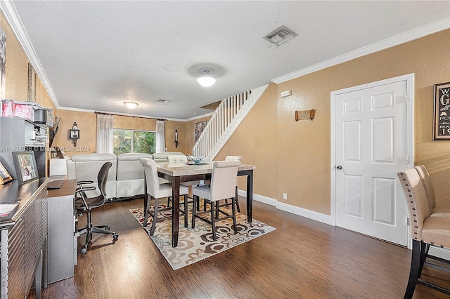 dining room featuring dark wood-type flooring and crown molding