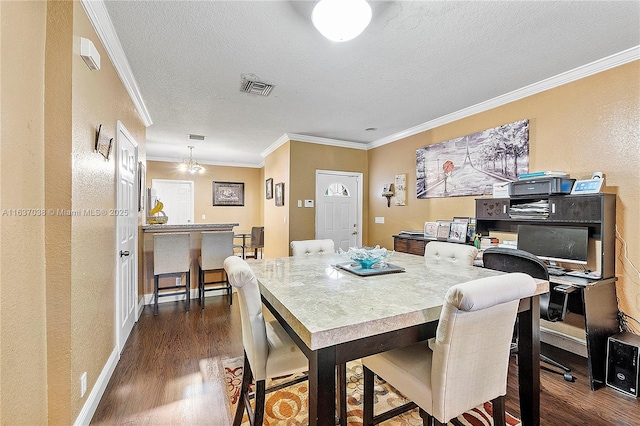 dining space featuring dark wood-style flooring, ornamental molding, a textured ceiling, a textured wall, and baseboards