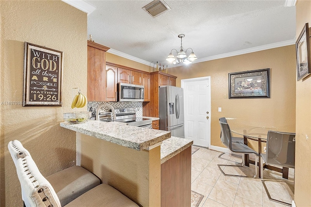 kitchen featuring stainless steel appliances, kitchen peninsula, backsplash, crown molding, and light tile patterned flooring