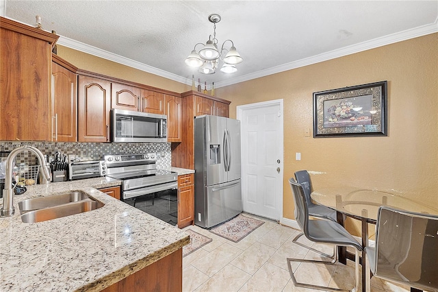 kitchen with appliances with stainless steel finishes, a sink, brown cabinets, a chandelier, and ornamental molding