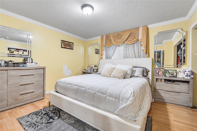 bedroom with light hardwood / wood-style floors, crown molding, and a textured ceiling