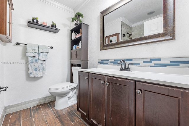 bathroom featuring vanity, crown molding, toilet, a textured ceiling, and backsplash