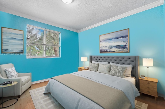 bedroom with ornamental molding, a textured ceiling, and hardwood / wood-style floors