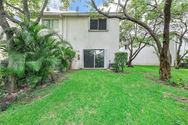 rear view of property with a yard