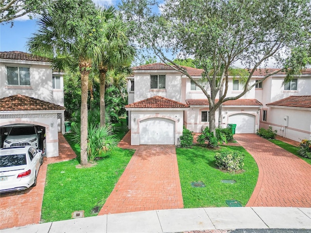 mediterranean / spanish-style home with decorative driveway, a tiled roof, stucco siding, and a front lawn