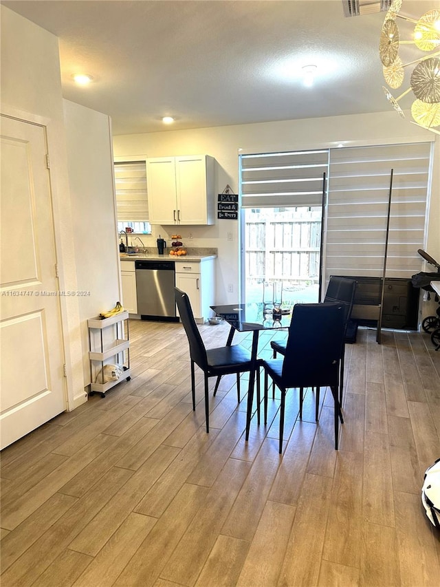 dining room with sink and light hardwood / wood-style flooring