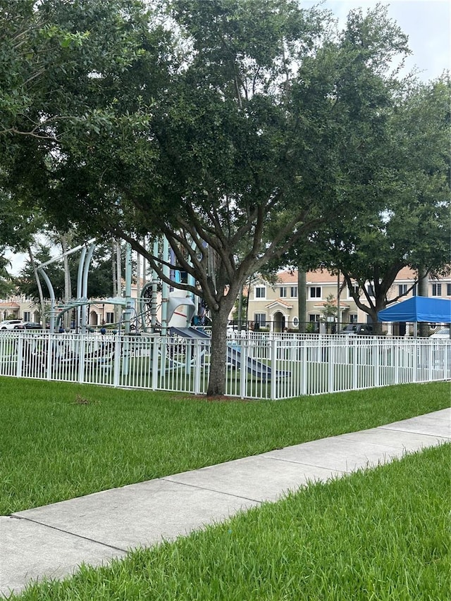 surrounding community with a playground and a yard