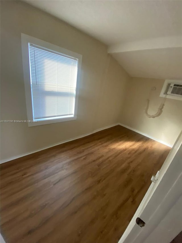 spare room with dark hardwood / wood-style flooring, plenty of natural light, and a textured ceiling