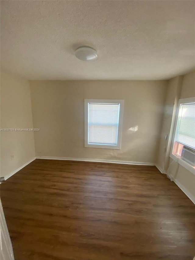 bathroom with tile patterned flooring, walk in shower, toilet, and vanity