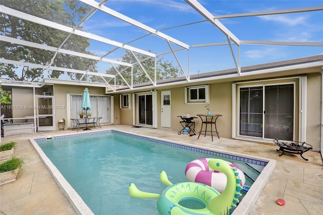 view of swimming pool with a lanai and a patio