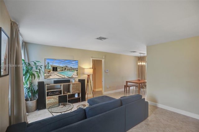 living room featuring light tile patterned flooring and a chandelier