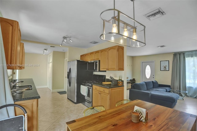 kitchen featuring sink, backsplash, pendant lighting, light tile patterned flooring, and appliances with stainless steel finishes