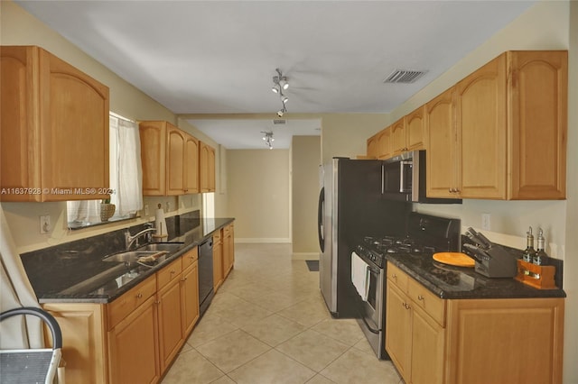 kitchen featuring sink, ceiling fan, dark stone countertops, light tile patterned flooring, and stainless steel appliances