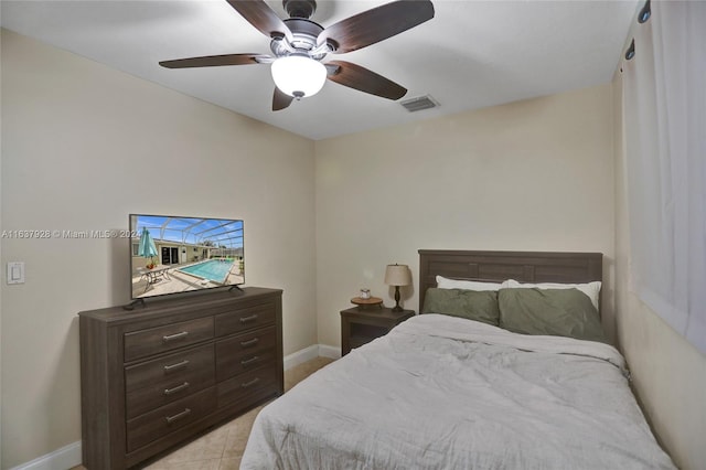 tiled bedroom featuring ceiling fan