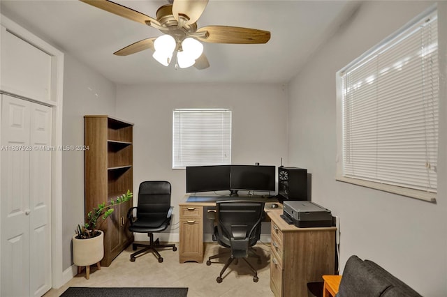 tiled office space featuring ceiling fan