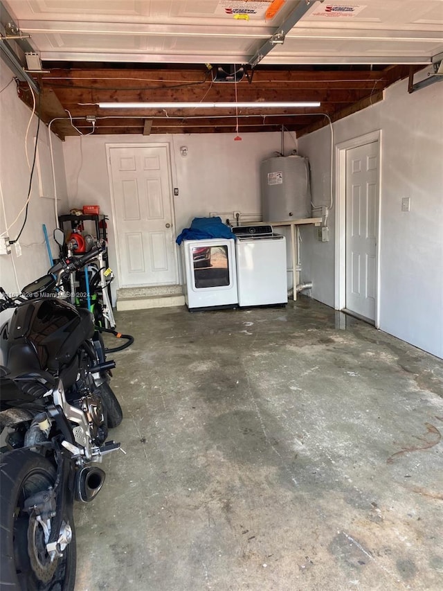 garage with washing machine and clothes dryer and water heater