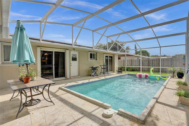 view of swimming pool with a lanai and a patio area