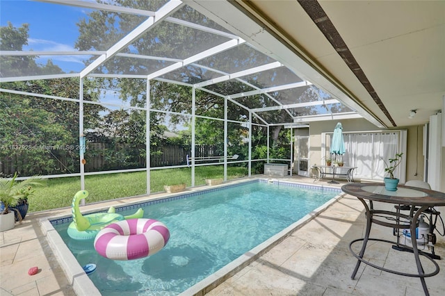 view of pool with a patio, a lanai, and a lawn