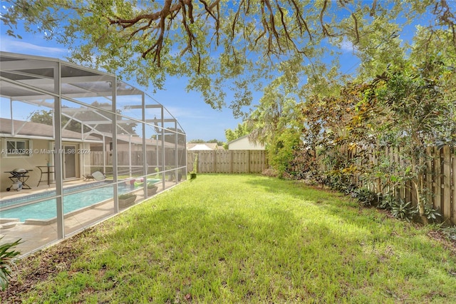 view of yard featuring a lanai and a fenced in pool