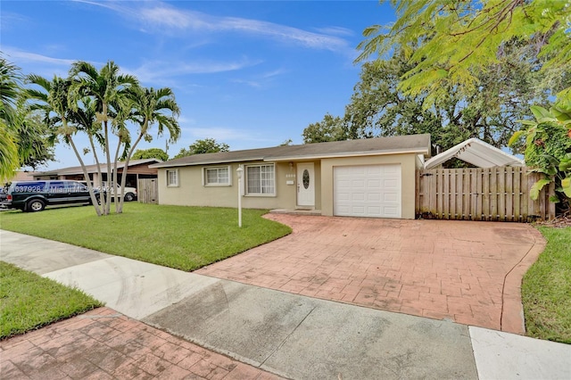 single story home with a garage and a front lawn