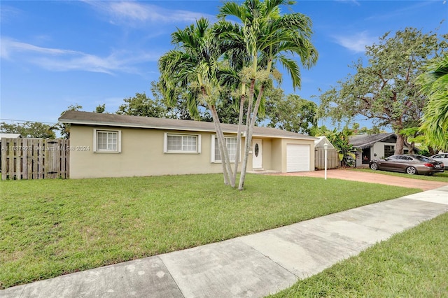 ranch-style home with a garage and a front yard