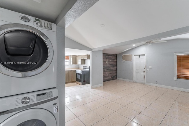 laundry area featuring ceiling fan, light tile patterned flooring, and stacked washer and dryer