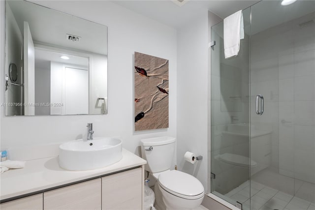 bathroom featuring an enclosed shower, vanity, and toilet