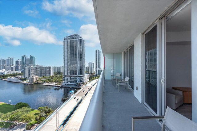 balcony with a view of city and a water view