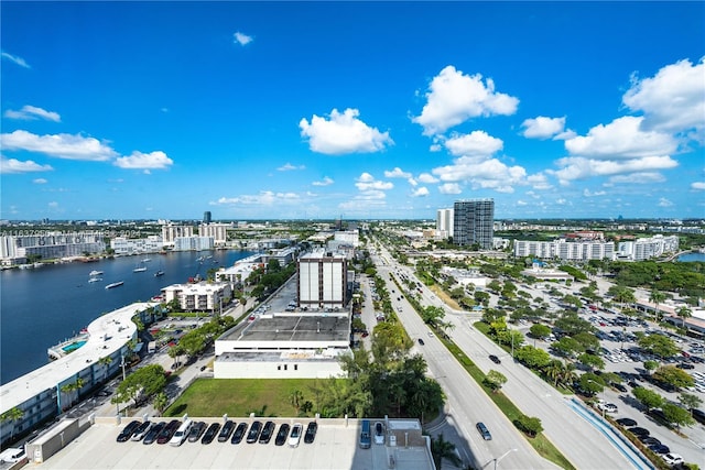 birds eye view of property featuring a water view and a city view