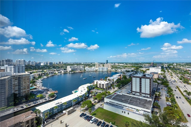 birds eye view of property with a city view and a water view