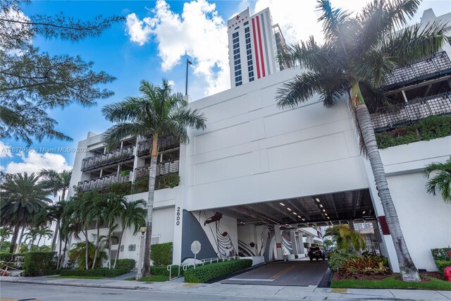 view of building exterior featuring covered parking