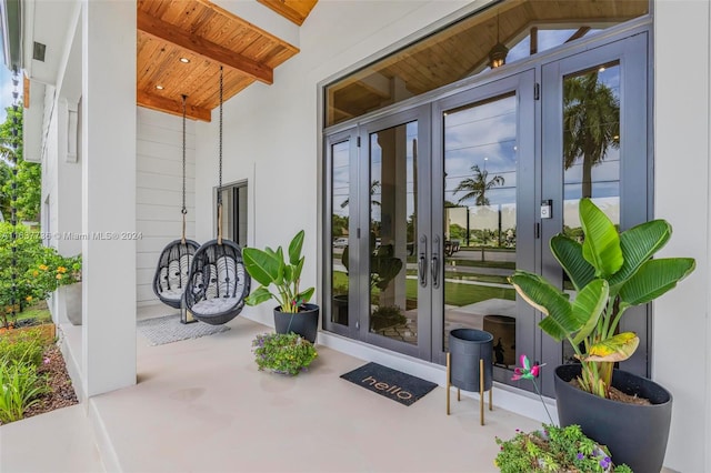 entryway featuring an inviting chandelier, a high ceiling, and light wood-type flooring