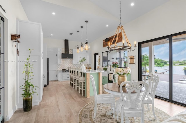 dining room with an inviting chandelier and light hardwood / wood-style flooring