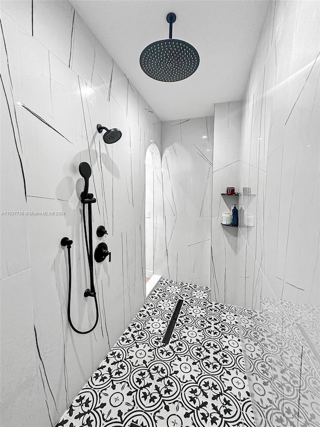 bathroom with tiled shower