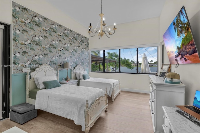 bedroom featuring a chandelier and light hardwood / wood-style floors