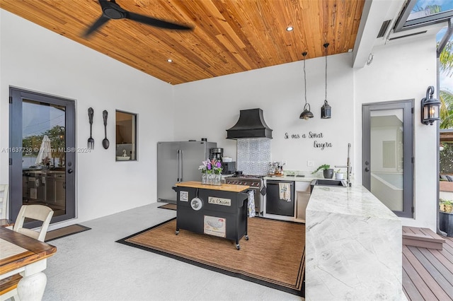 kitchen featuring butcher block countertops, stainless steel appliances, wood ceiling, and premium range hood