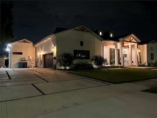 view of front of home with a yard and a garage