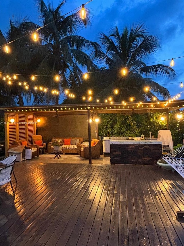 deck at twilight with outdoor lounge area