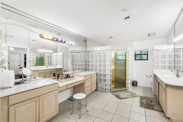 bathroom featuring tile patterned flooring, vanity, toilet, and walk in shower