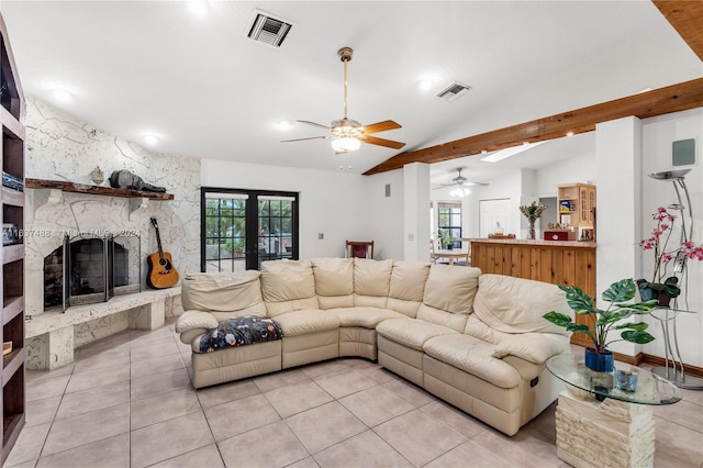 tiled living room featuring vaulted ceiling with beams, a fireplace, and french doors