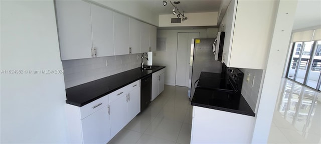 kitchen with light tile patterned flooring, black dishwasher, decorative backsplash, and white cabinets