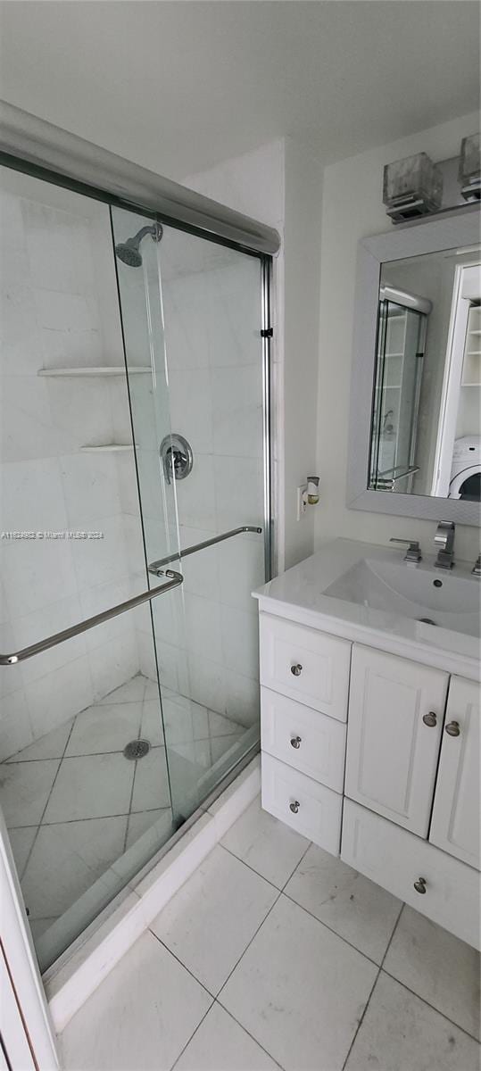 bathroom with vanity, walk in shower, and tile patterned floors