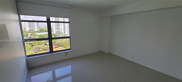 spare room with tile patterned flooring