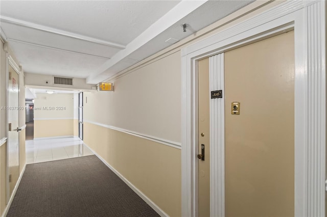 corridor with light tile patterned floors