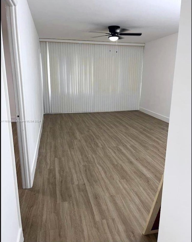 unfurnished room with hardwood / wood-style floors and ceiling fan