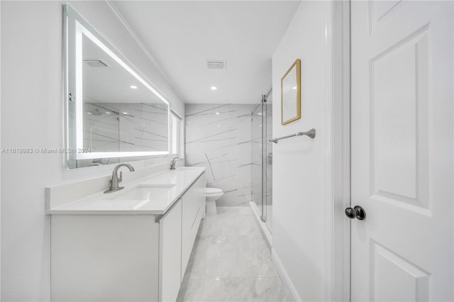 bathroom featuring tile patterned flooring, a shower with door, toilet, and vanity