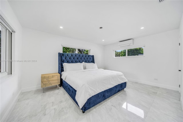 bedroom with a wall unit AC and light tile patterned flooring